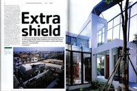 a magazine with a picture of a house and an extra shield