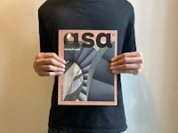 a man holding up a magazine with the word asa on it