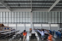 the interior of a school with many tables and chairs