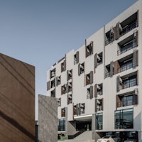 an apartment building with a car parked in front of it