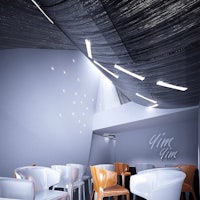 an image of a restaurant with chairs and a ceiling