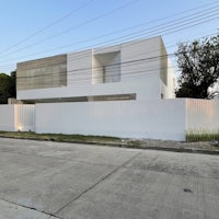 a white house on the side of a street