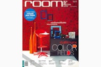 the cover of room magazine with a red chair and red wall