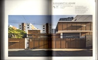 a magazine with a picture of a house and a building