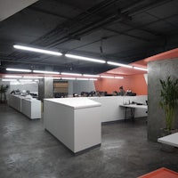 the interior of an office with orange and white walls