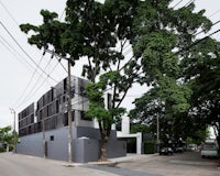 a modern house with a tree in front of it