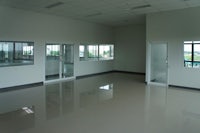 an empty office with glass doors and windows