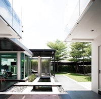 a modern house with glass walls and a swimming pool