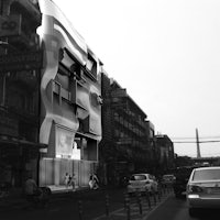 a black and white photo of a building on a street