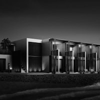 a black and white image of a modern house on the beach