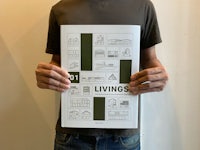 a man holding up a book that says 30 livings