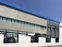 a building with a blue roof and a car parked in front of it