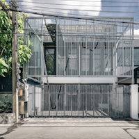 a house with a metal fence in front of it