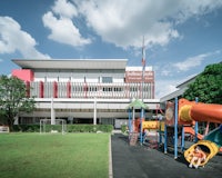 a playground in front of a school building