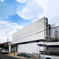 a white building with a car parked in front of it