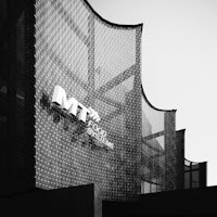 a black and white photo of a building with the word mtm on it