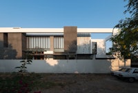 a modern house with a car parked in front of it