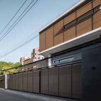 a house with a wooden fence on the side of the street