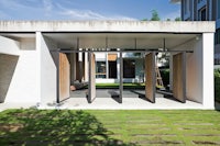 a modern house with glass doors and a grassy area