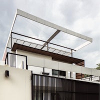 a modern house with a metal roof and a balcony