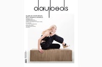 the cover of daybeads magazine with a woman sitting on top of a wooden box